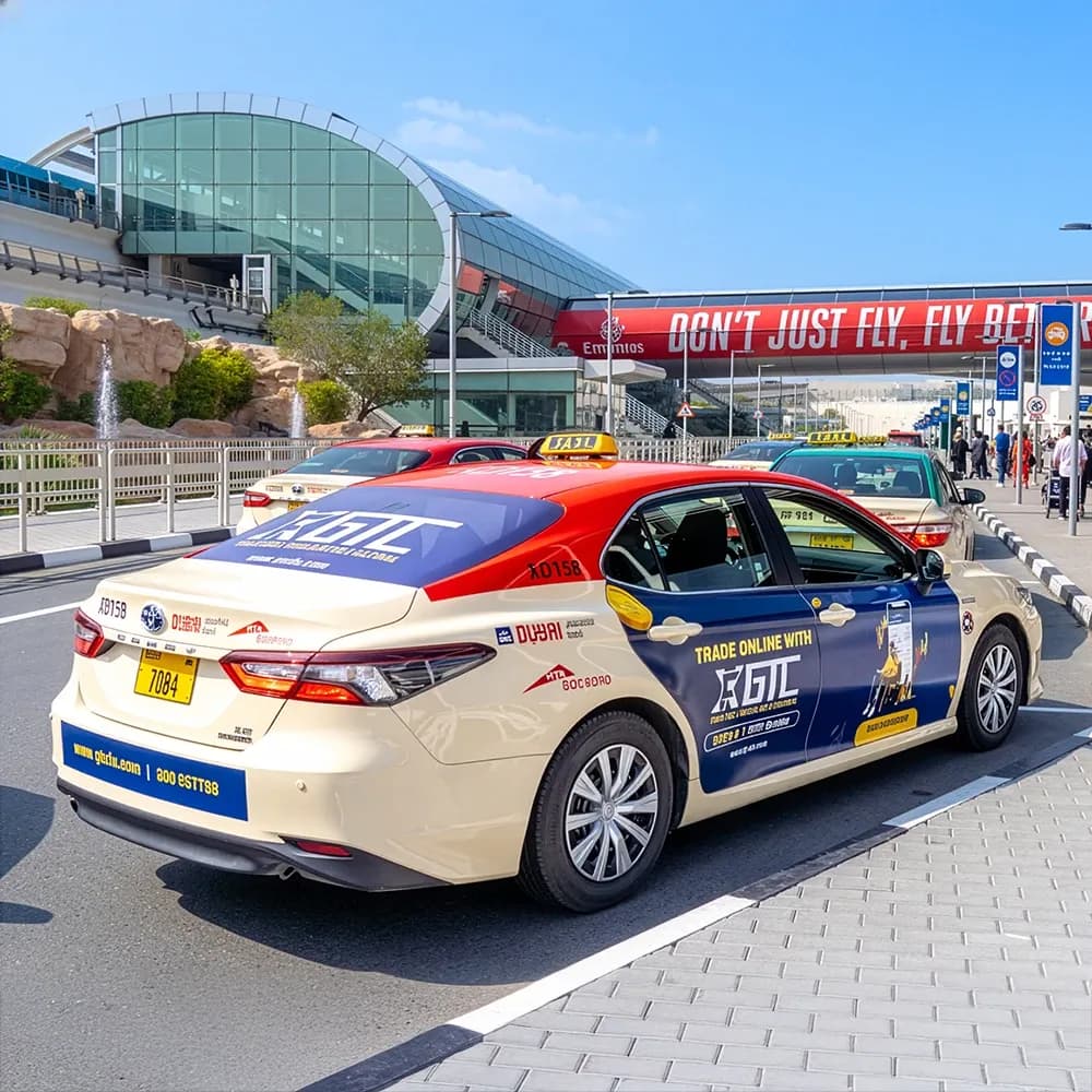 Dubai RTA taxi door branding advertising for Any Volt Car Repair (أي فولت لتصليح السيارات) — mobile taxi wrap campaign in Dubai featuring full side panel vehicle branding with contact details and automotive repair services promotion.
